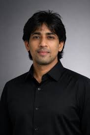 Portrait of Prady K., the creator and host of DataPodcast, a series exploring AI architecture and decision science.